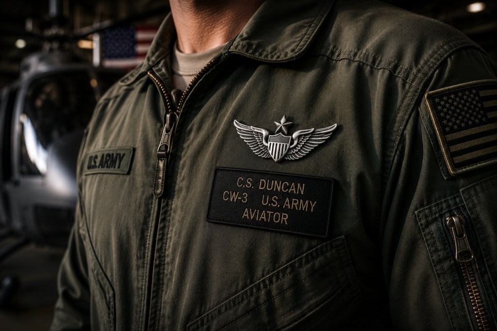 Close-up cinematic image of U.S. Army Senior Aviator wings displayed on a military flight jacket inside an aviation hangar.